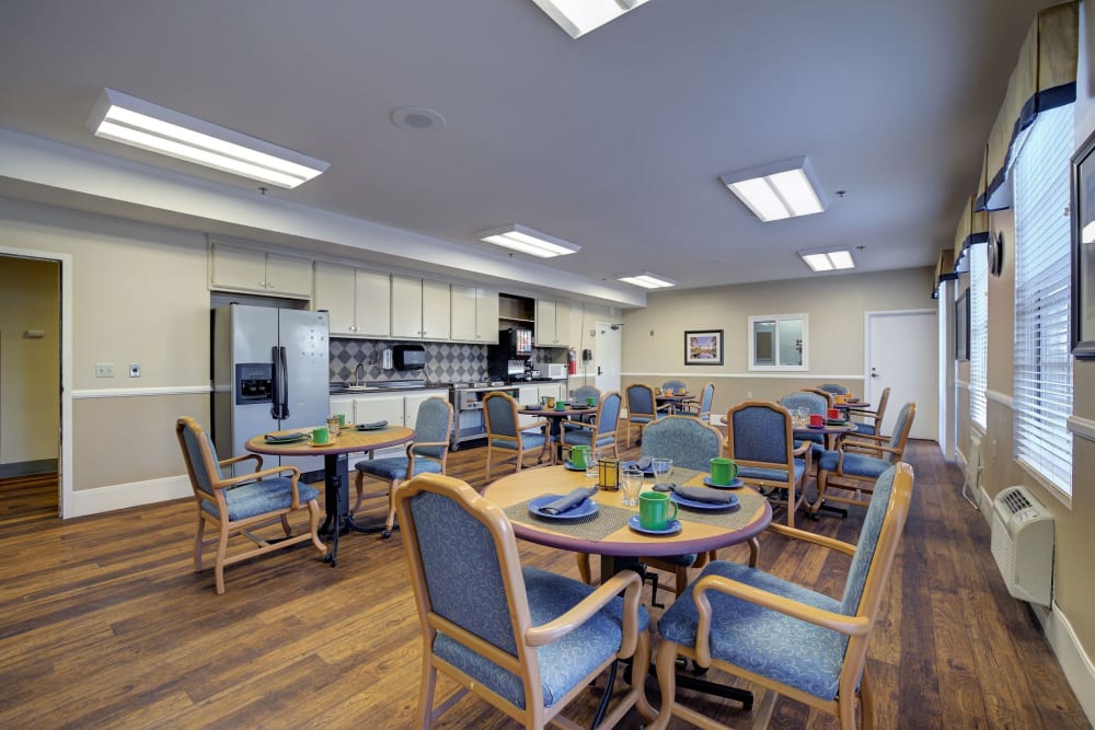 Dining room with kitchen at Pacifica Senior Living Bonita in Chula Vista, California