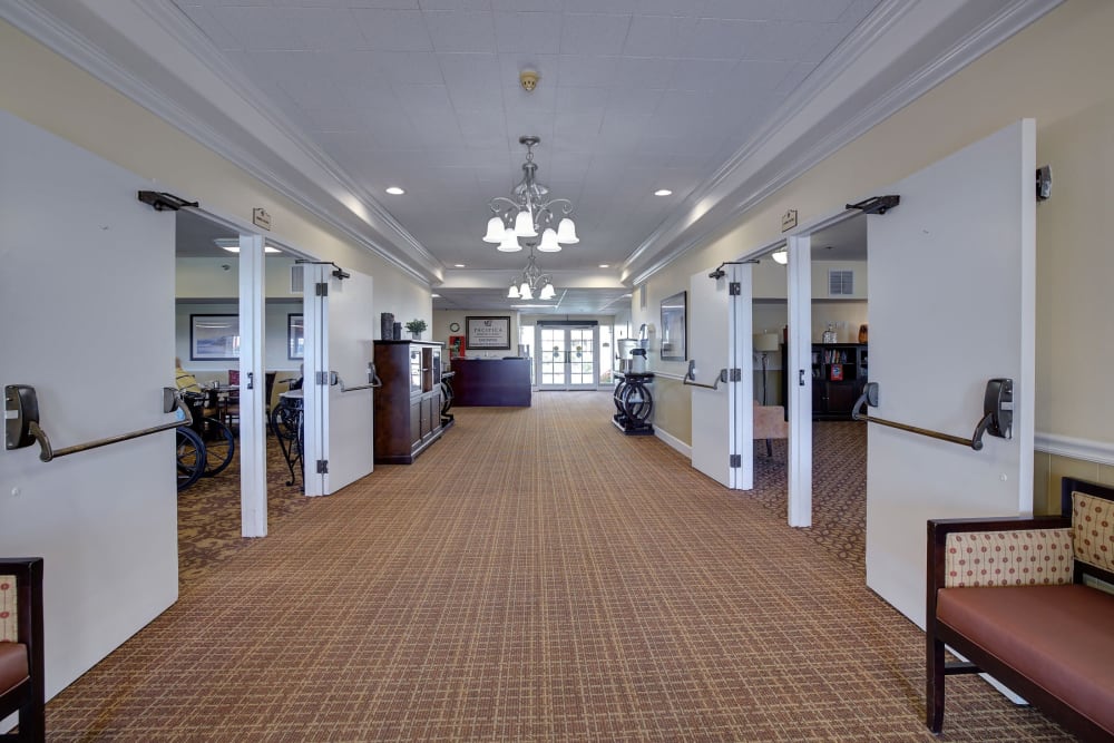 Large hallway to dining room and reception area at Pacifica Senior Living Encinitas in Encinitas, California