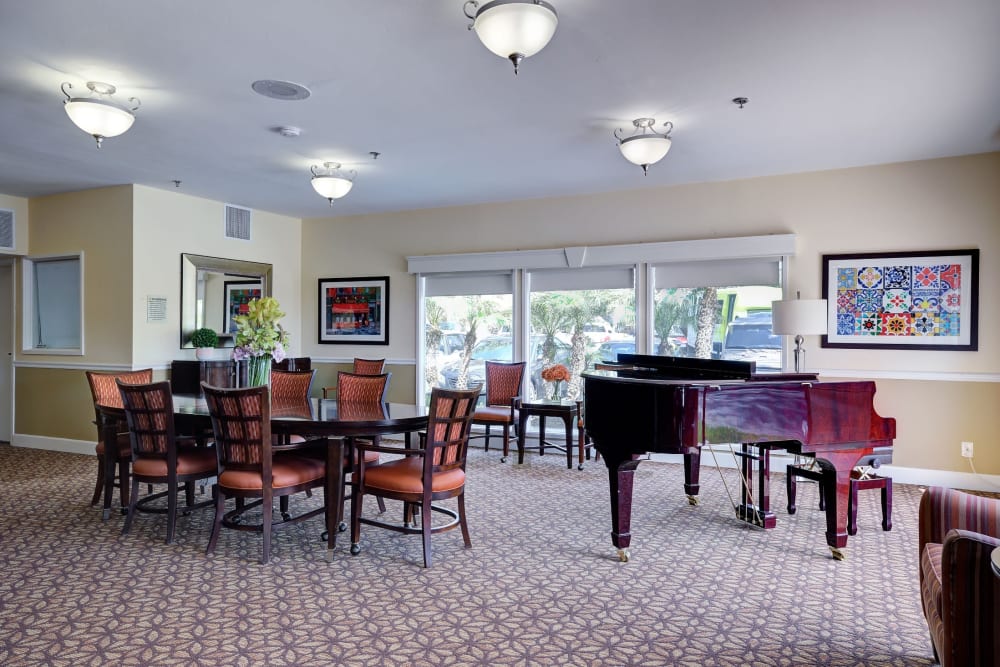 Dining area with piano at Pacifica Senior Living Encinitas in Encinitas, California