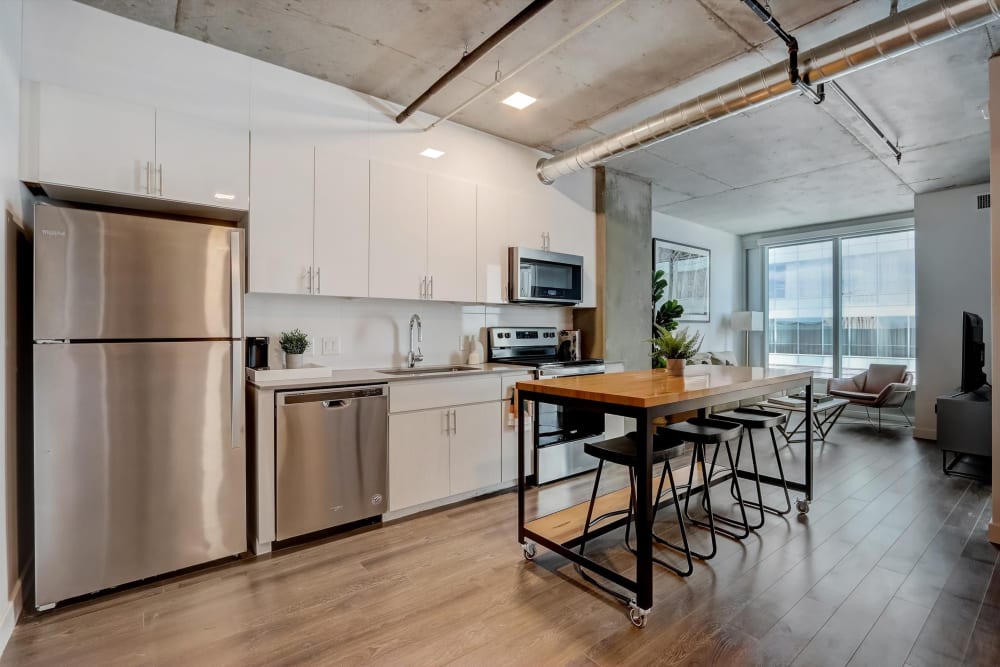 Modern kitchen with white cabinetry and stainless-steel appliances in a coliving apartment at Kenect Nashville in Nashville, Tennessee