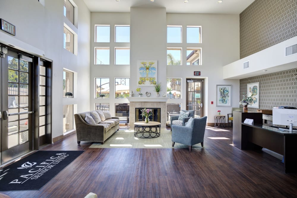 Reception desk and lounge area with couches at Pacifica Senior Living Rancho Peñasquitos in San Diego, California