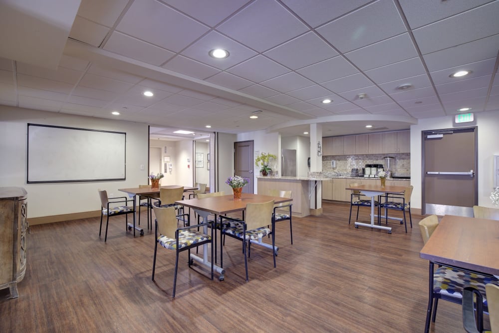 Resident dining area with multiple tables and chairs at Pacifica Senior Living Rancho Peñasquitos in San Diego, California