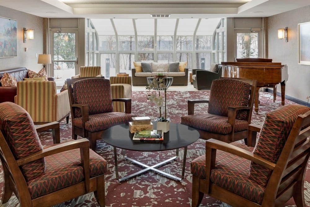 Resident lounge area with multiple lounge chairs and couches at Vernon Terrace of Edina in Edina, Minnesota