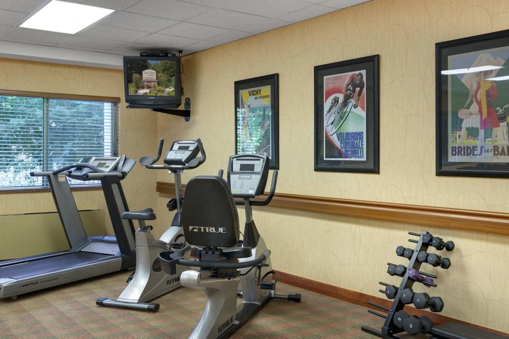 Exercise room with workout equipment and dumbbells at Vernon Terrace of Edina in Edina, Minnesota