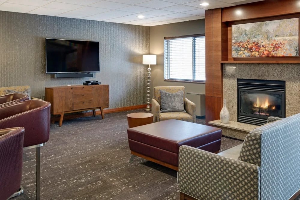 Resident entertainment room with television, seating, and fireplace at Vernon Terrace of Edina in Edina, Minnesota