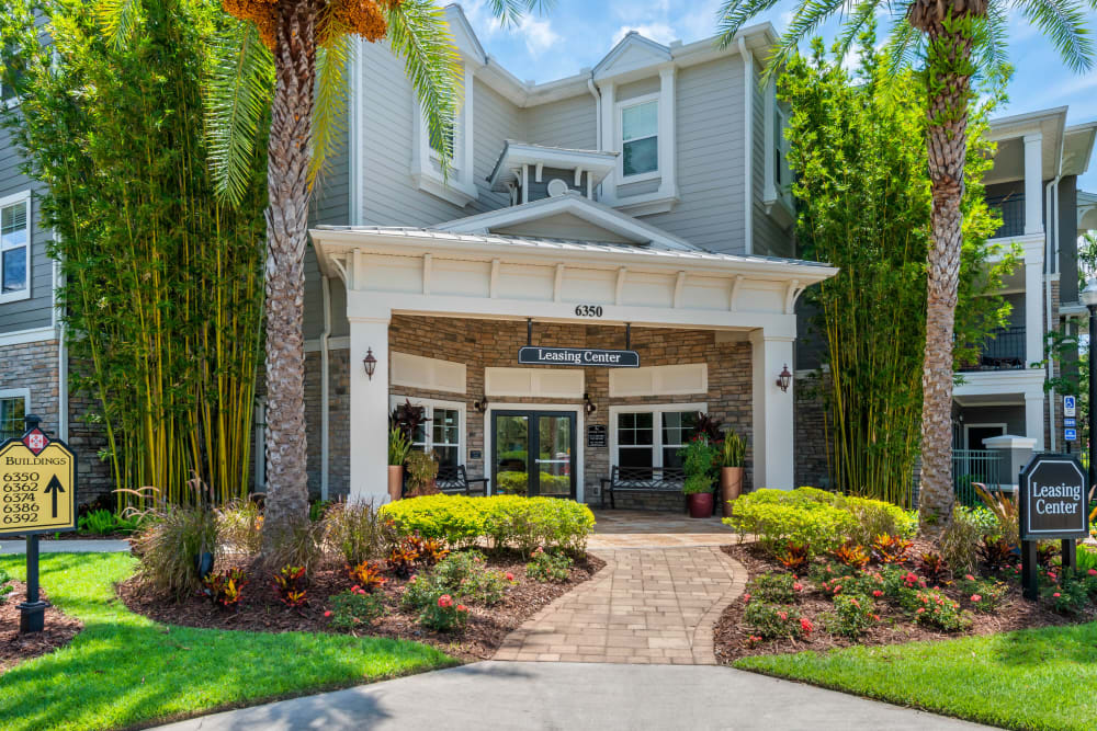 Beautiful exterior surrounded by palm trees at Regatta at Universal Apartments in Orlando, Florida