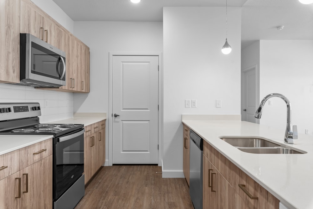 Kitchen with wooden cabinets at The Kelton Apartments in ,UT