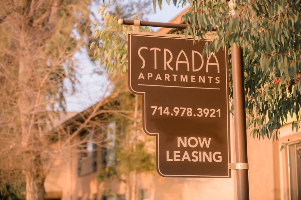 'now leasing' signage outside of Strada Apartments in Orange, California