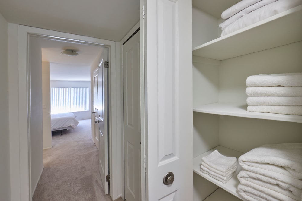 Hallway closet with linens and a view of bedroom at The Marquette in Milford, Michigan