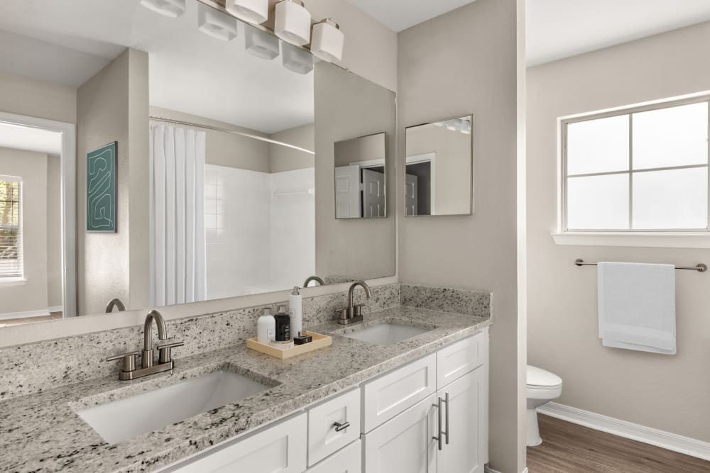 Island with a granite countertop in the open-concept kitchen of a model home at Cape House in Jacksonville, Florida