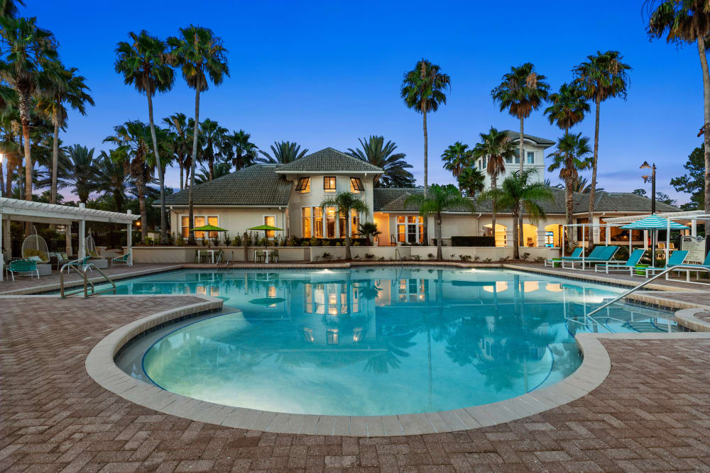 Dusk view of the swimming pool with underwater lights on at Cape House in Jacksonville, Florida