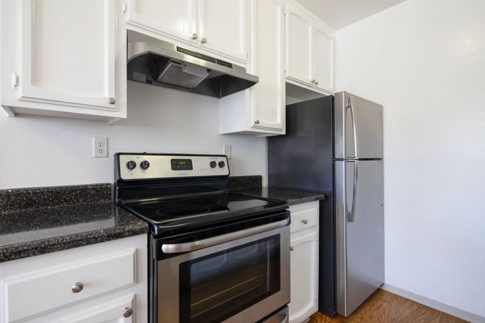 Kitchen with modern appliances at Royal Village Apartments in San Diego, California