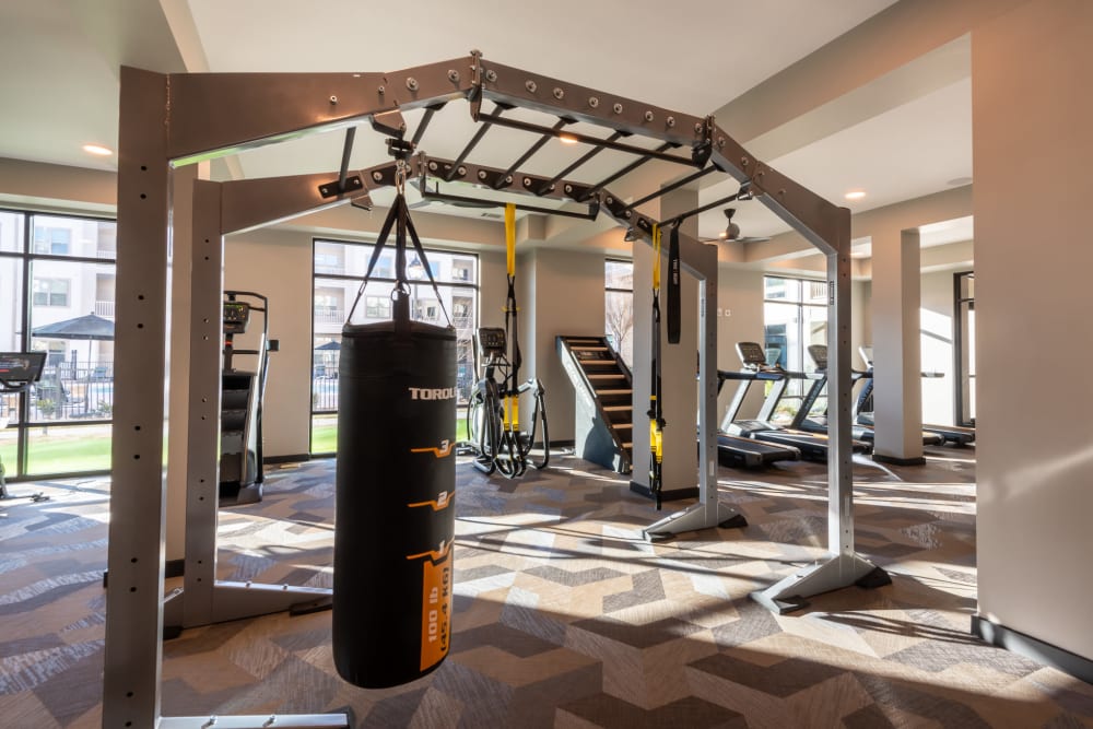 Punching bag and a variety of cardio machines in the state of the art fitness center at The Reserve at Patterson Place in Durham, North Carolina