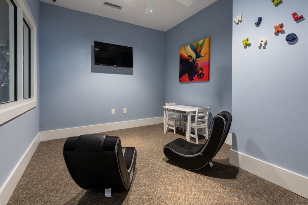 Kids area with a tv and chairs at The Reserve at White Oak in Garner, North Carolina
