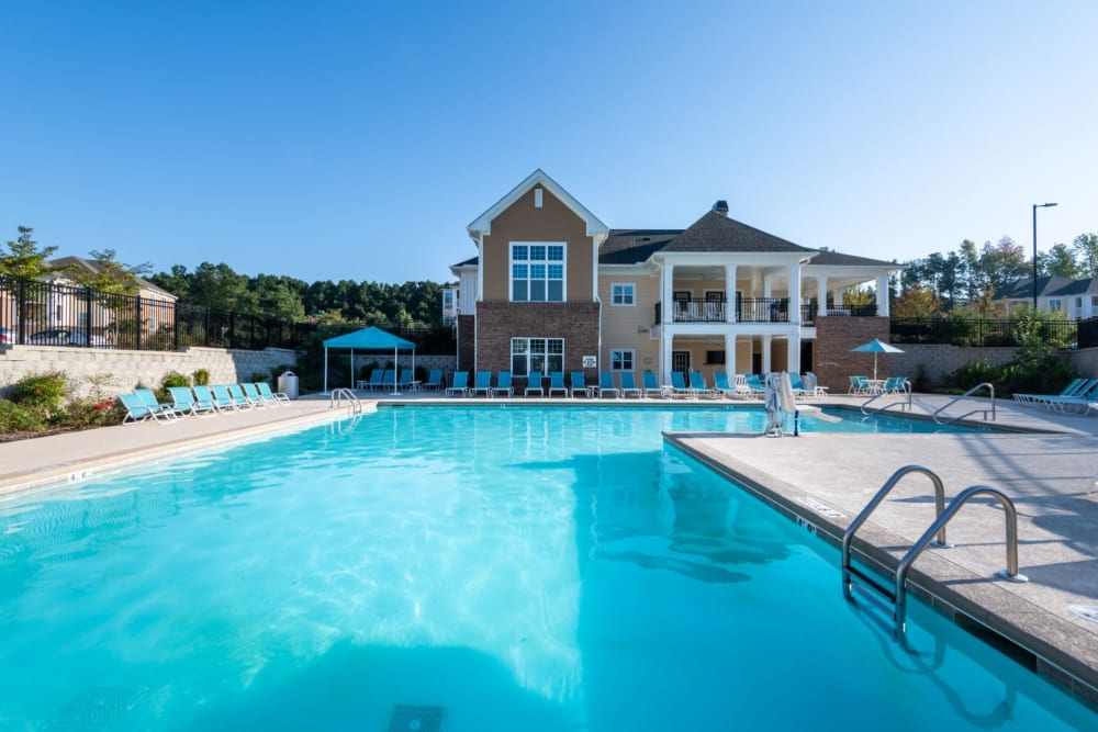 Massive resort style pool surrounded by lounge chairs at The Reserve at White Oak in Garner, North Carolina