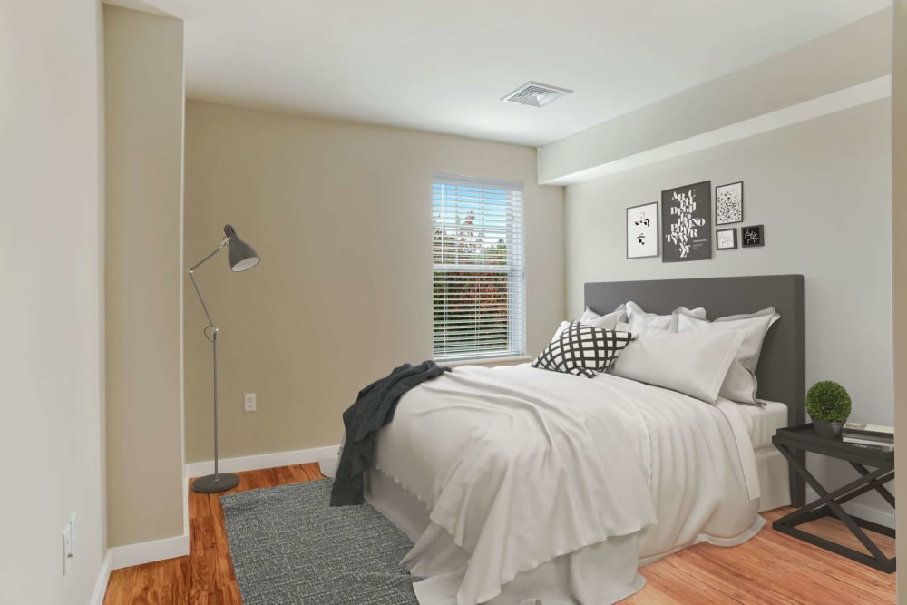 Furnished bedroom with large bed at Bay Ridge at Nashua Apartments in Nashua, New Hampshire