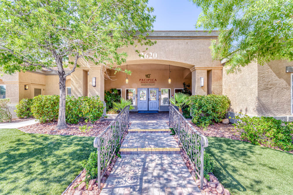 Entrance view with garden on the side at Pacifica Senior Living Green Valley in Henderson, Nevada