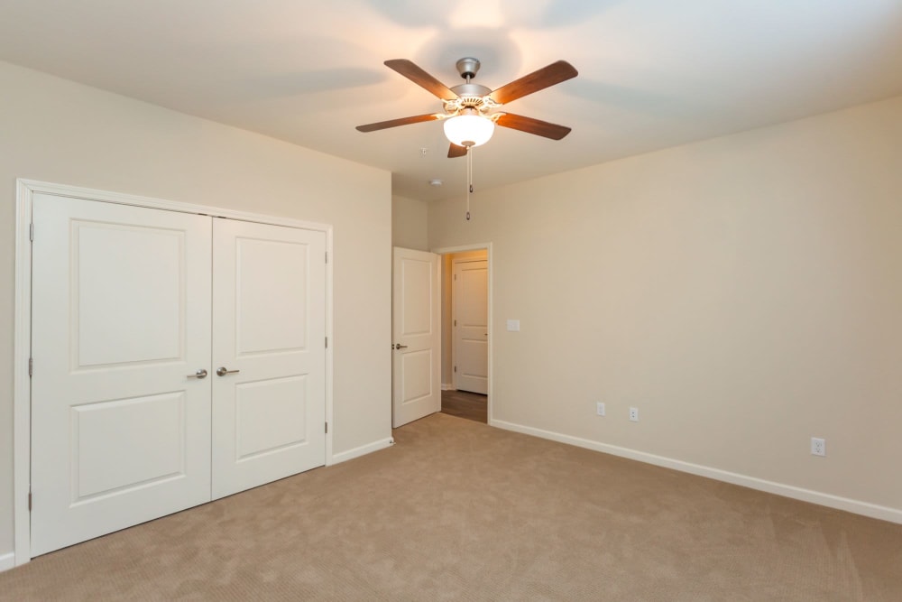 Bedroom with large closet doors shut at Madison Crest Apartment Homes in Madison, Tennessee