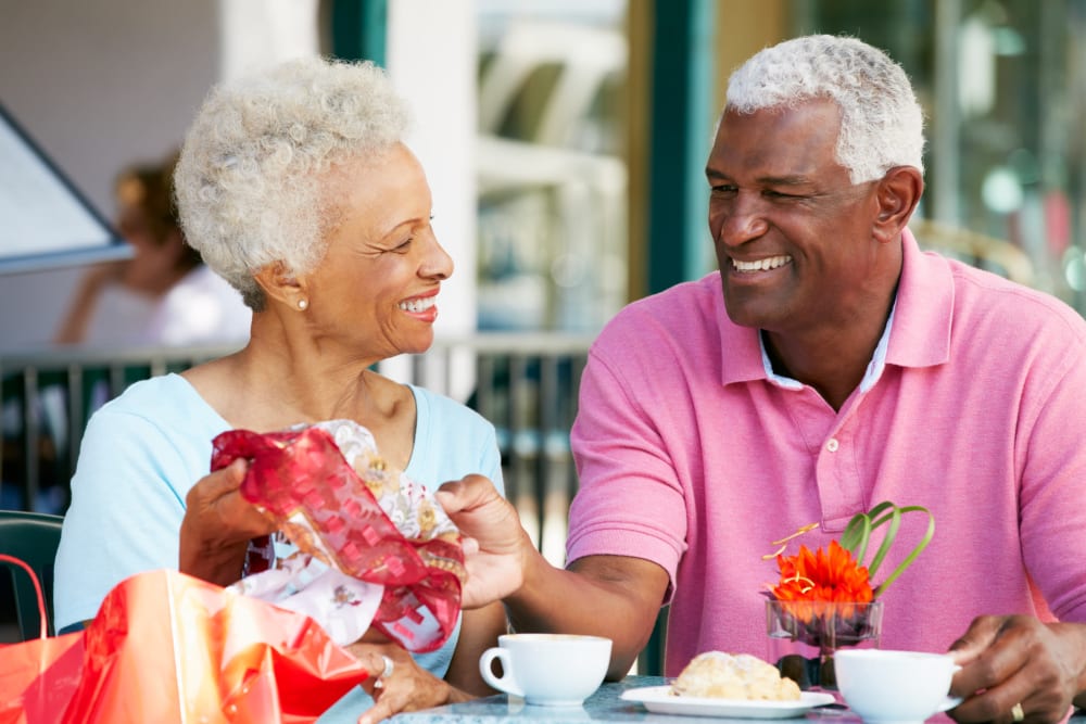 Senior couple enjoying a meal at a cafe near New Shiloh Village Senior Apartments in Baltimore, Maryland