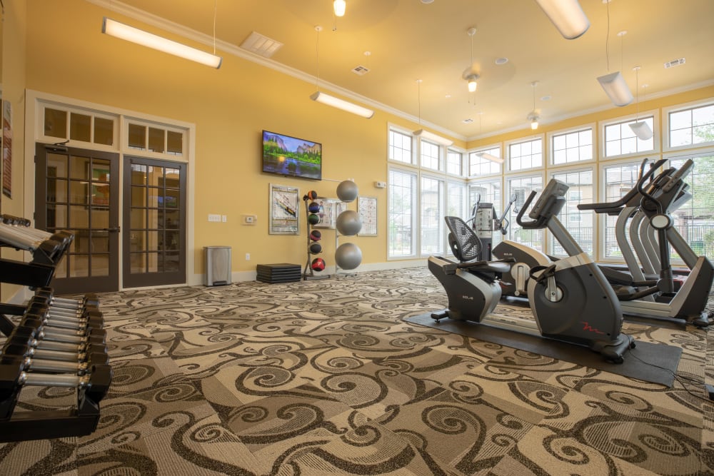 Exercise equipment in the community fitness center at Cypress Creek Wayside Drive in Houston, Texas