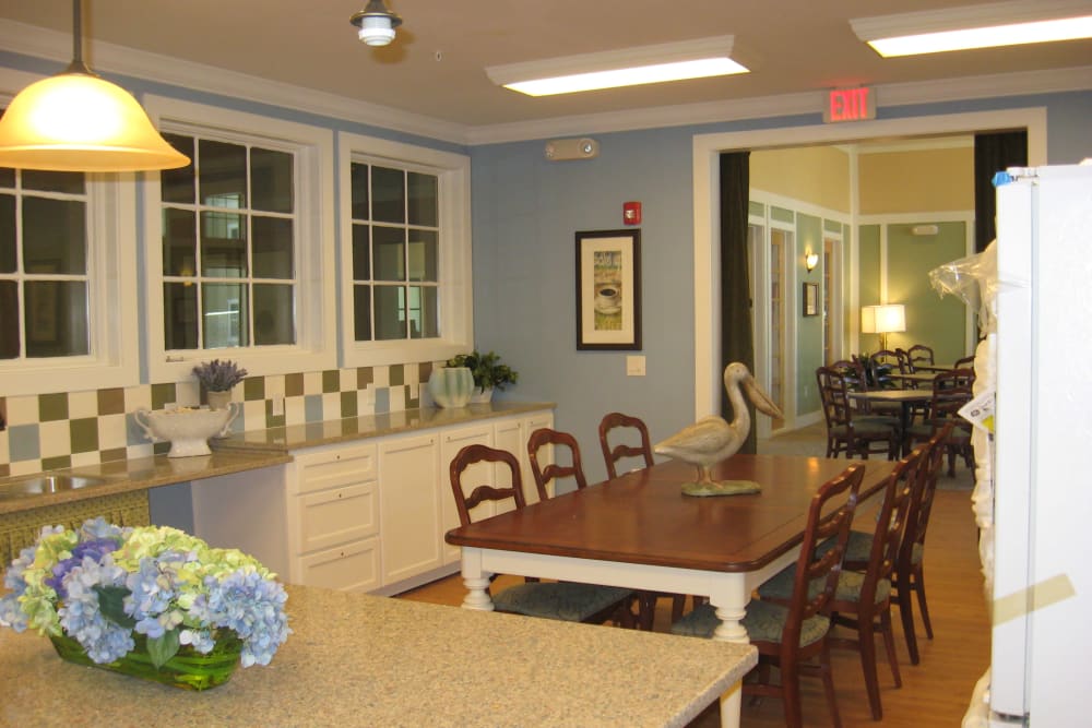 A large dining table in the community kitchen at Mariposa at River Bend in Georgetown, Texas