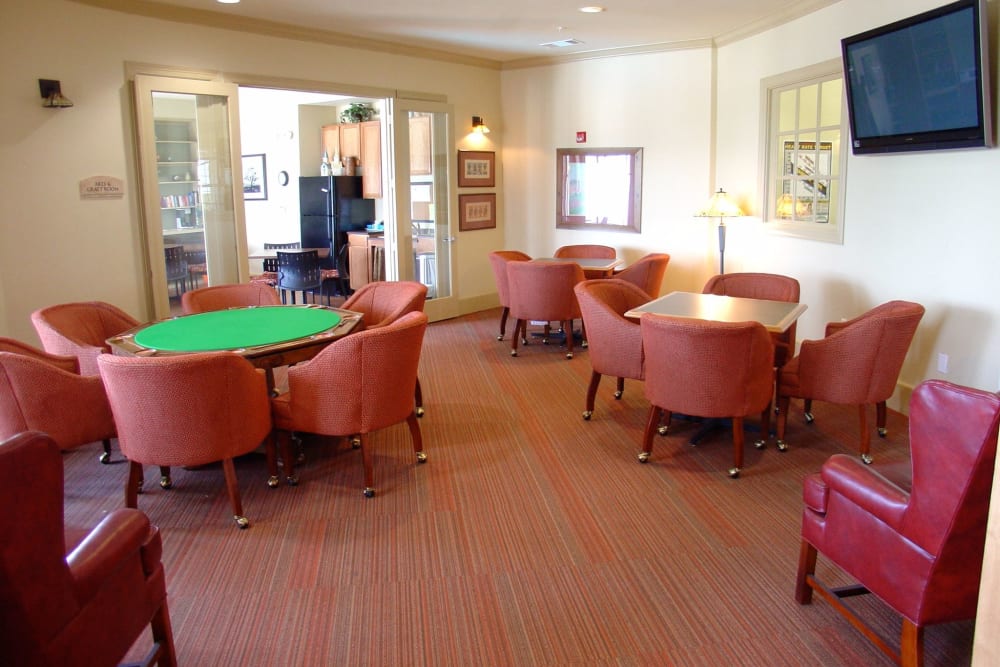Seating around tables in the community clubhouse at Mariposa at River Bend in Georgetown, Texas