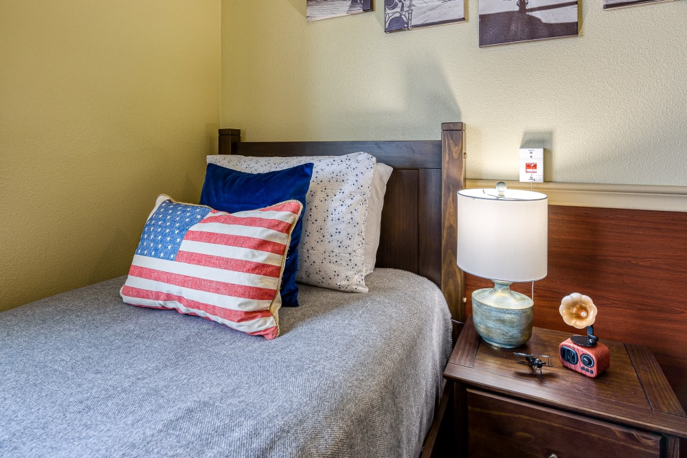 Single bed at Pacifica Senior Living San Martin in Las Vegas, Nevada with US flag designed pillow