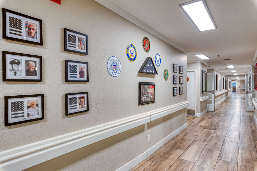 Hallway decorated with picture frames  at  Pacifica Senior Living Santa Clarita in Newhall, California