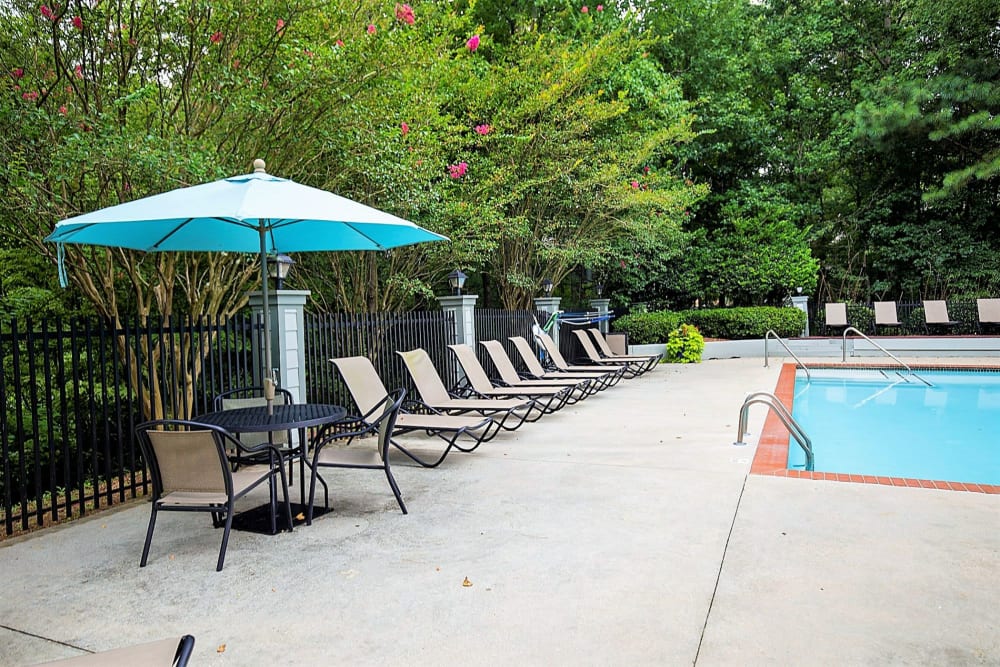 Leisure area at pool with chairs Lake Crossing Apartment Homes in Austell, Georgia