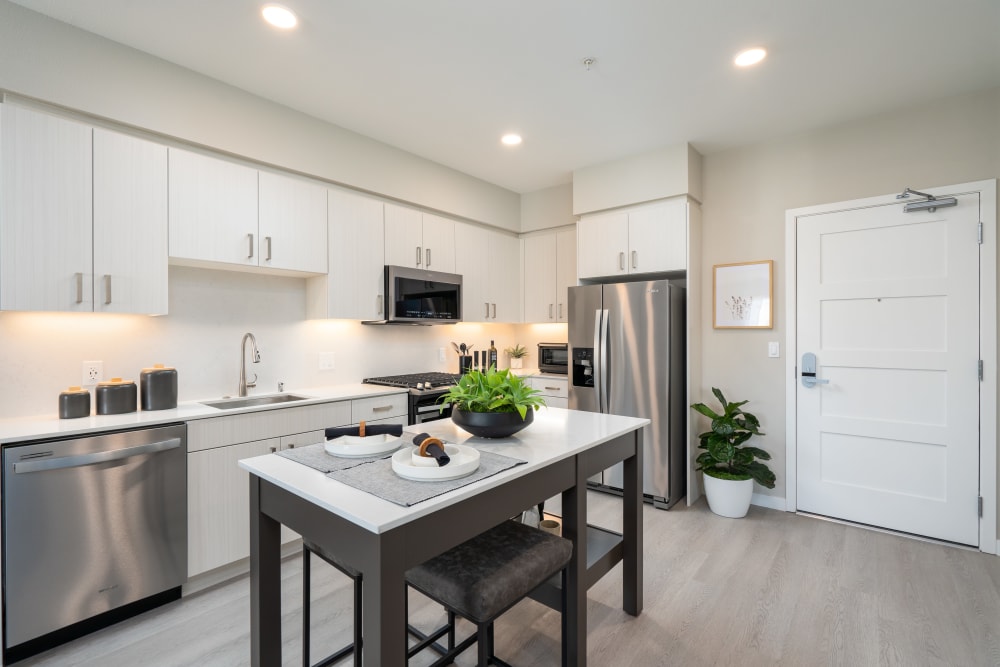 Modern kitchen with solid white countertops at Anson in Burlingame, California
