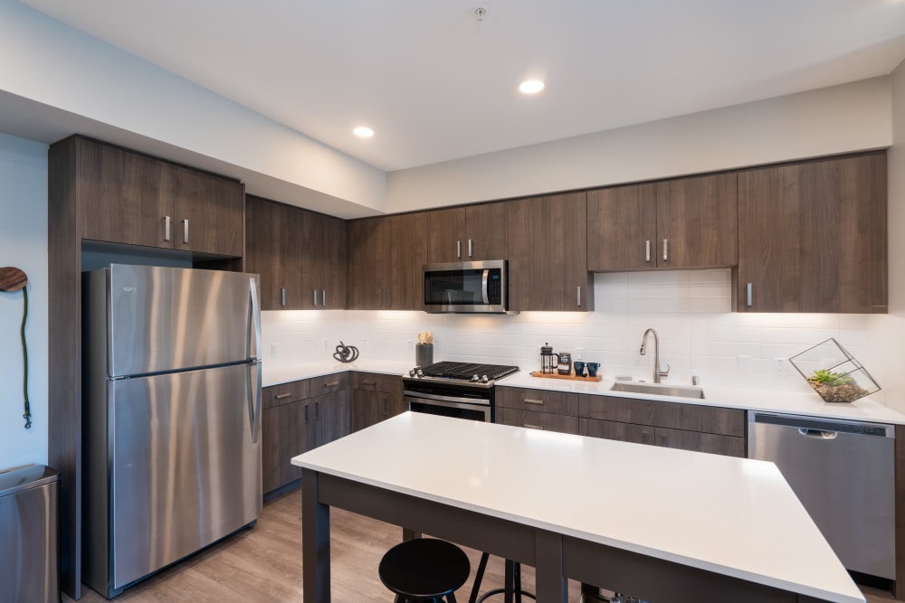 Kitchen with stainless-steel appliances and island at Anson in Burlingame, California