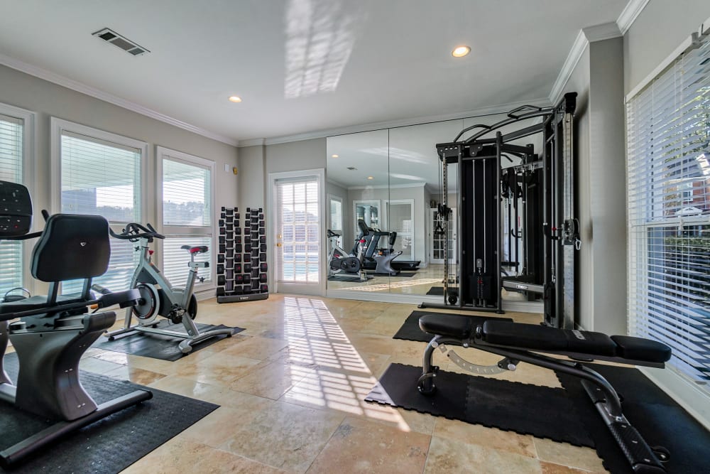 Fitness center with dumbbells at The Gatsby at Midtown Apartment Living in Montgomery, Alabama