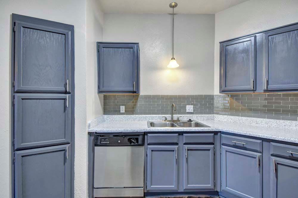 Kitchen with wood cabinets at {location_name}} in Duncanville, Texas