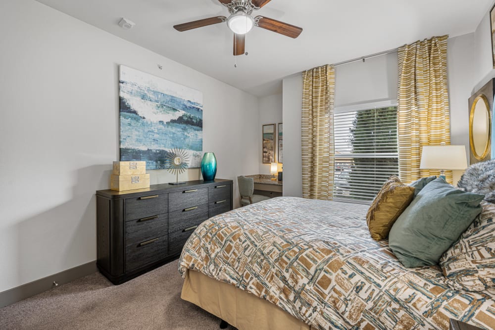 Model master bedroom with carpet style flooring at The Residences at Panther Hollow in Marble Falls, Texas