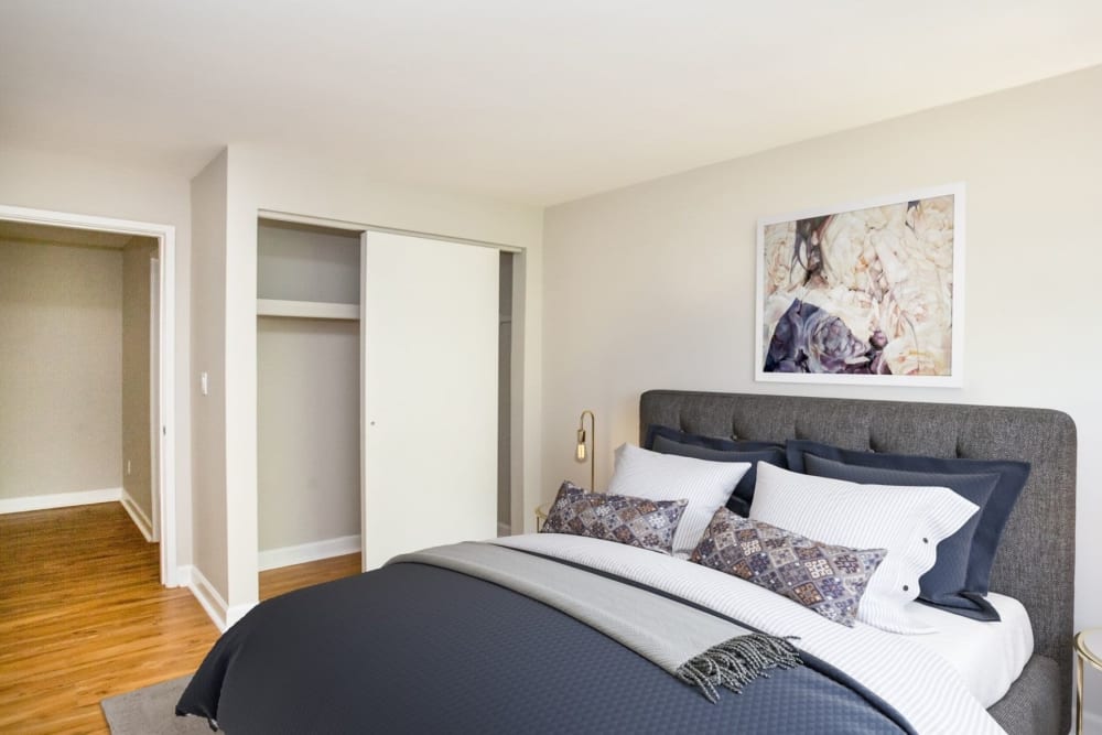 Bedroom with comfortable bedding at Eagle Rock Apartments & Townhomes at Brighton in Brighton, Massachusetts