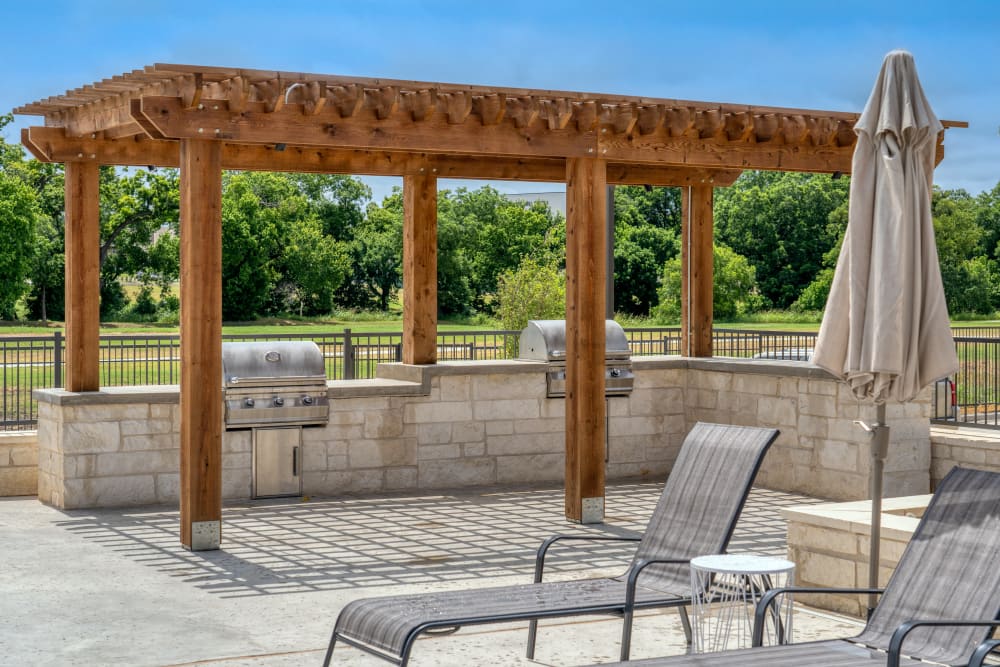 Community barbecue area under a cabana at The Gates at Meadow Place in Willow Park, Texas