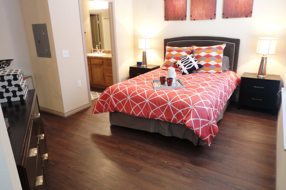 Spacious maser bedroom with hardwood style flooring at Anatole at City View in Lubbock, Texas
