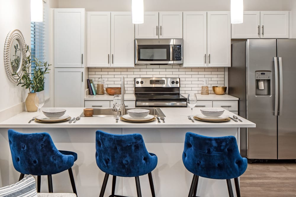 Open kitchen interior with three chairs displaying at Ravello 192 in Elkhorn, Nebraska