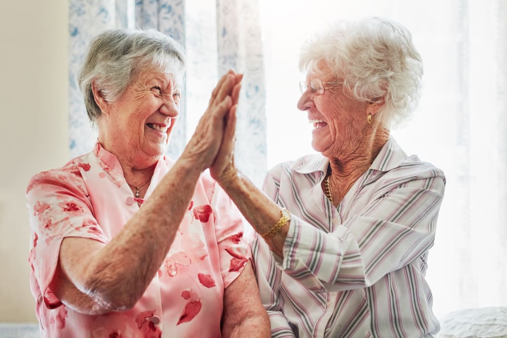 Residents high-fiving at Edencrest at Timberline in Urbandale, Iowa
