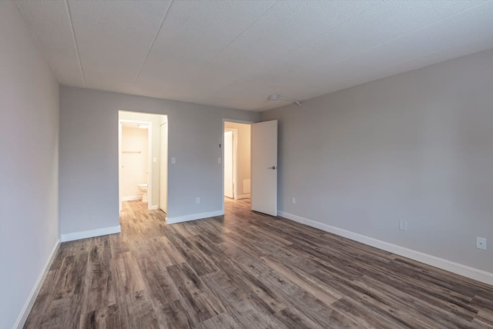 Bedroom with beautiful hardwood floors at Eagle Rock Apartments at MetroWest in Framingham, Massachusetts
