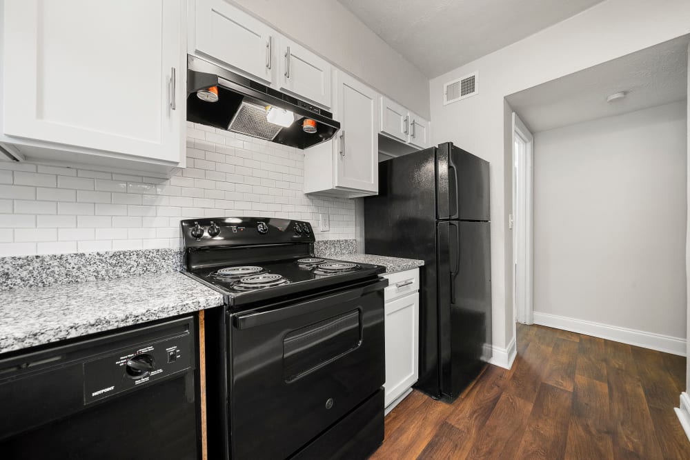 Kitchen with nice black appliances at The Crossing at Henderson Mill Apartment Homes in Atlanta, Georgia