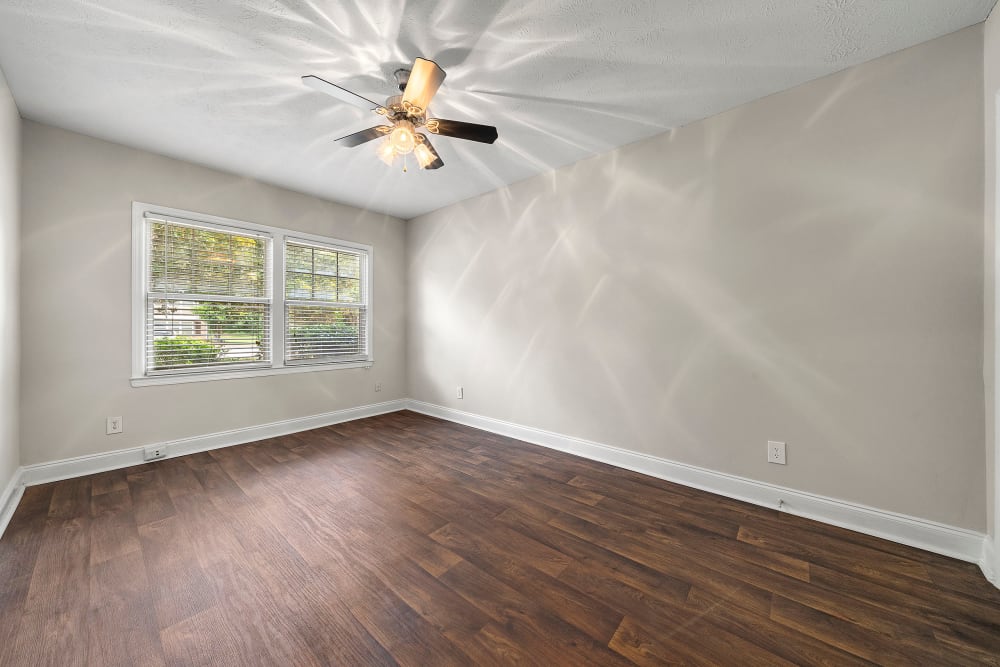 Bedroom with hardwood floors at The Crossing at Henderson Mill Apartment Homes in Atlanta, Georgia