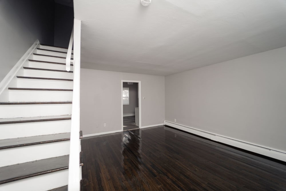 Living room area with stairs at Encore 99 in East Haven, Connecticut