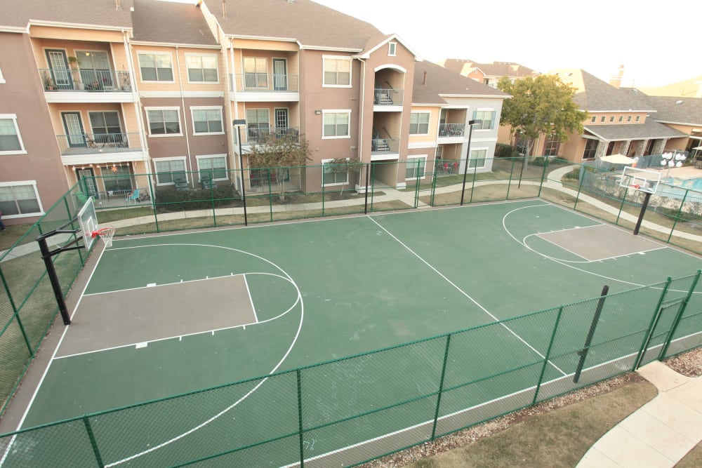 Outdoor basketball court for residents at Cypress Creek at River Bend in Georgetown, Texas