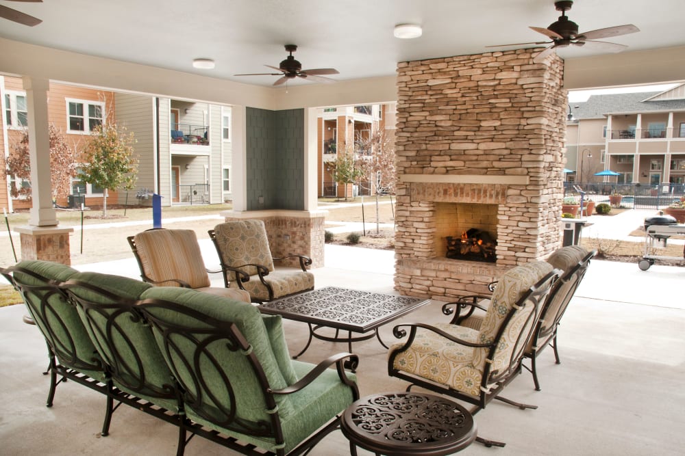Outdoor patio seating by a fireplace at Mariposa at Bay Colony in Dickinson, Texas