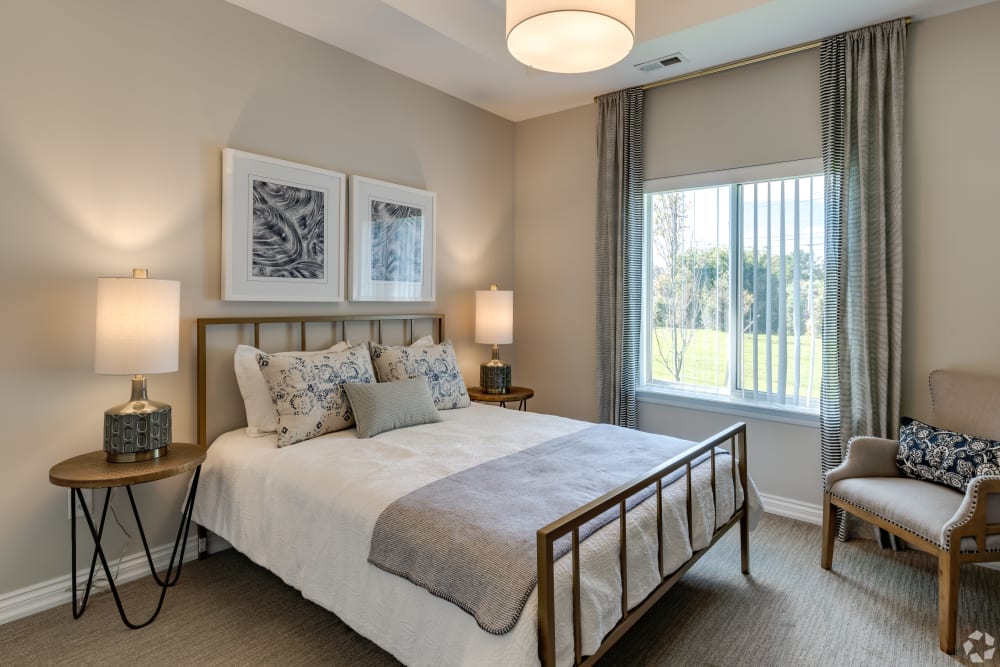 Bedroom with overhead lighting at Encore at Deerhill in Clarkston, Michigan