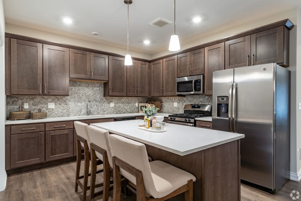 Kitchen with stainless-steel appliances at Encore at Deerhill in Clarkston, Michigan
