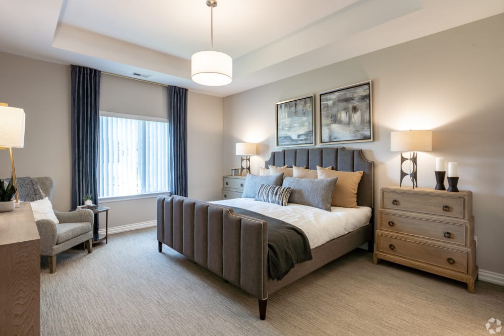 Model living room with large windows at Encore at Deerhill in Clarkston, Michigan