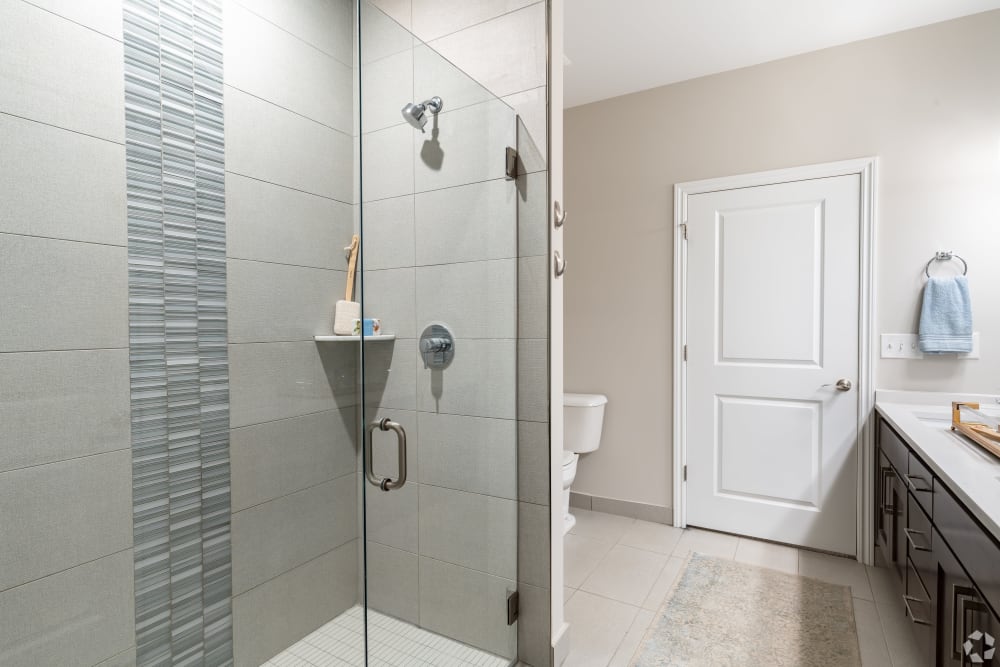 Bathroom with glass shower doors at Encore at Deerhill in Clarkston, Michigan