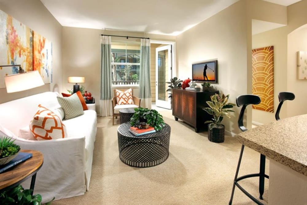 Furnished and carpeted living room at Artisan at East Village Apartments in Oxnard, California